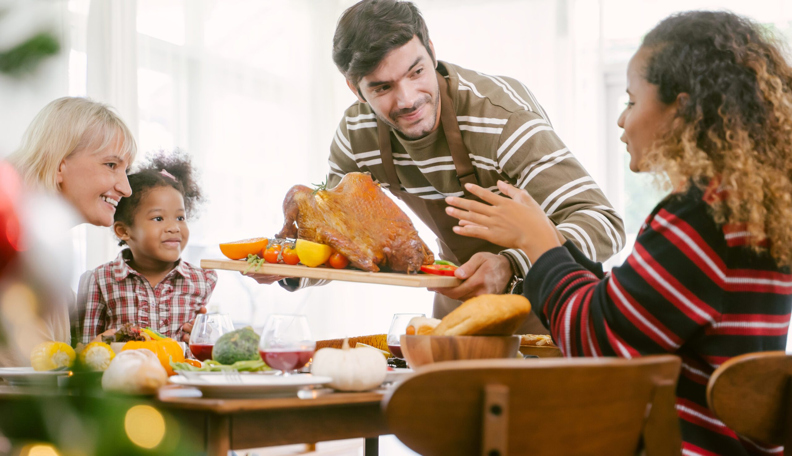 bigstock-Father-Carrying-Turkey-Served--324872740