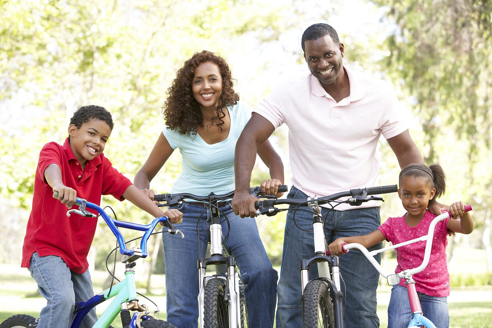 bigstock-Young-Family-Riding-Bikes-In-P-13909514